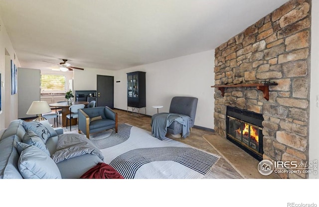 3526 S Depew St Unit 102, Lakewood, CO 80235 - living room featuring a fireplace, ceiling fan, and baseboards