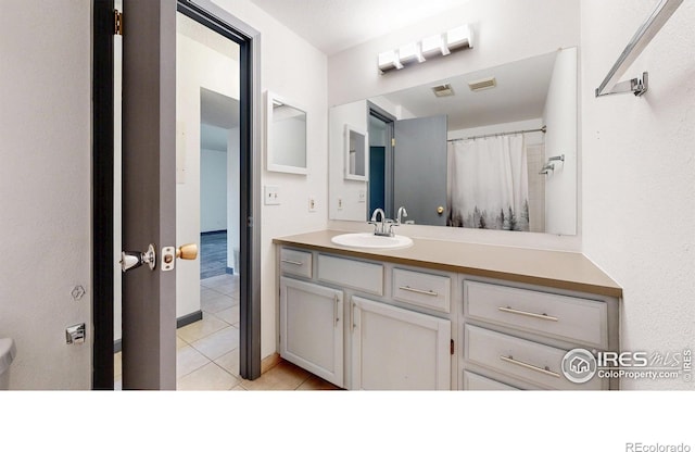 3526 S Depew St Unit 102, Lakewood, CO 80235 - bathroom featuring tile patterned flooring and vanity