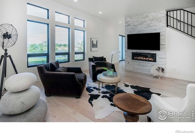 1769 Beachside Dr, Windsor, CO 80550 - living room with wood finished floors, a fireplace, and recessed lighting
