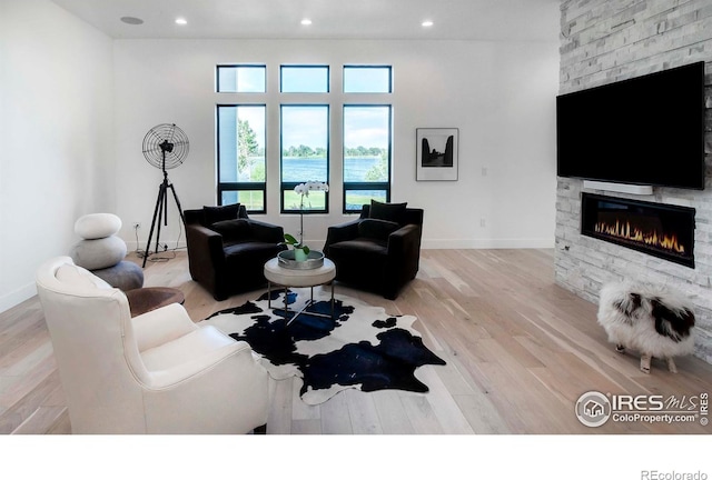 1769 Beachside Dr, Windsor, CO 80550 - living area featuring a fireplace, wood finished floors, recessed lighting, and baseboards