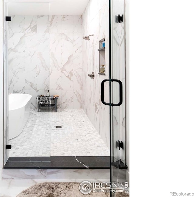 1769 Beachside Dr, Windsor, CO 80550 - bathroom with a soaking tub, a marble finish shower, and marble finish flooring