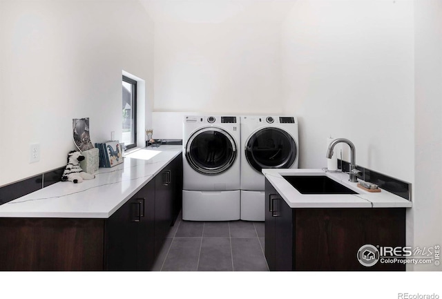 1769 Beachside Dr, Windsor, CO 80550 - laundry area with washer and clothes dryer, light tile patterned floors, and cabinet space