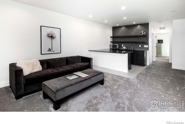 1769 Beachside Dr, Windsor, CO 80550 - living area featuring light carpet, recessed lighting, and baseboards