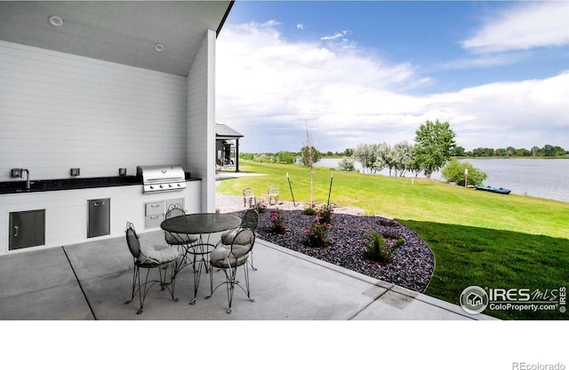 1769 Beachside Dr, Windsor, CO 80550 - view of patio / terrace with a sink, a water view, and outdoor dining area