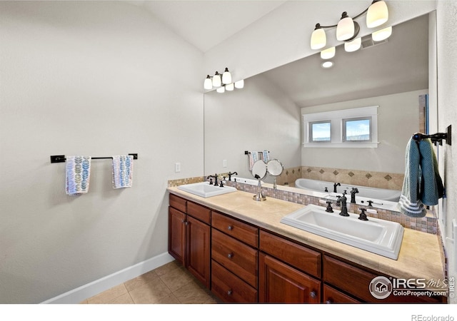 2005 Calico Ct, Longmont, CO 80503 - bathroom featuring tile patterned flooring, a bath, double vanity, vaulted ceiling, and baseboards