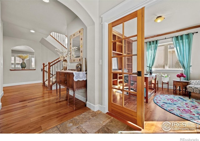 2005 Calico Ct, Longmont, CO 80503 - entryway with baseboards, arched walkways, stairway, wood finished floors, and recessed lighting