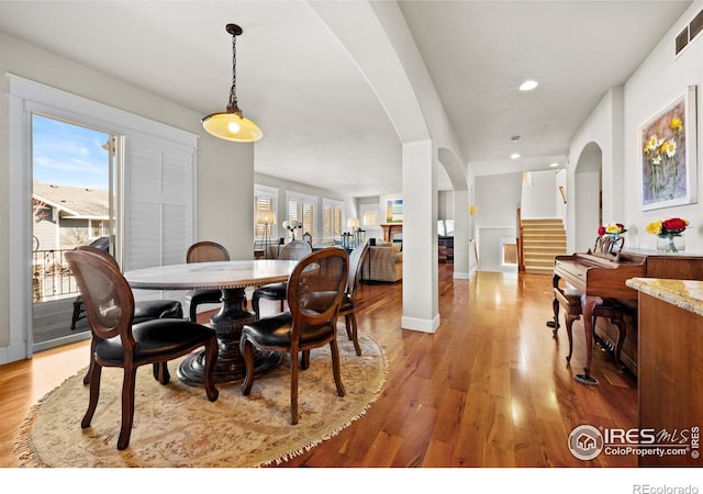 2005 Calico Ct, Longmont, CO 80503 - dining space with arched walkways, light wood-style floors, stairway, recessed lighting, and baseboards