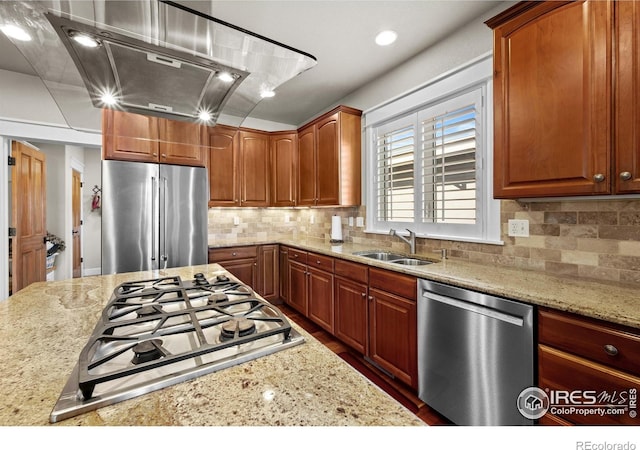 2005 Calico Ct, Longmont, CO 80503 - kitchen with stainless steel appliances, a sink, range hood, light stone countertops, and tasteful backsplash