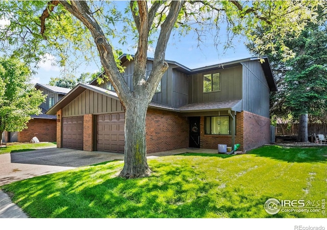 2840 W 21st St Unit 14, Greeley, CO 80634 - view of front of property with brick siding, driveway, a garage, and board and batten siding