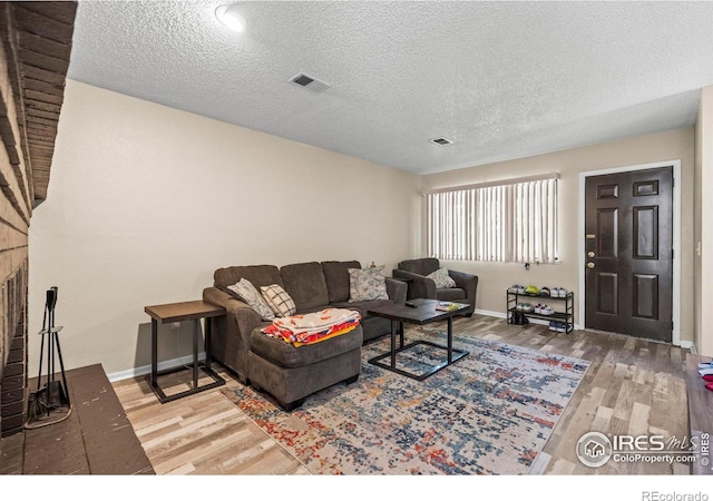 2840 W 21st St Unit 14, Greeley, CO 80634 - living area with wood finished floors, baseboards, and a textured ceiling