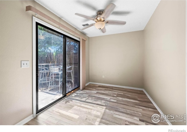 2840 W 21st St Unit 14, Greeley, CO 80634 - spare room with wood finished floors, a ceiling fan, and baseboards