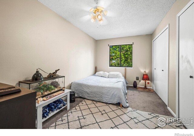 2840 W 21st St Unit 14, Greeley, CO 80634 - carpeted bedroom featuring a textured ceiling, ceiling fan, and baseboards