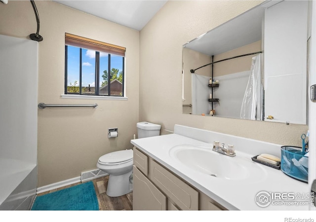 2840 W 21st St Unit 14, Greeley, CO 80634 - bathroom featuring vanity, toilet, baseboards, and wood finished floors