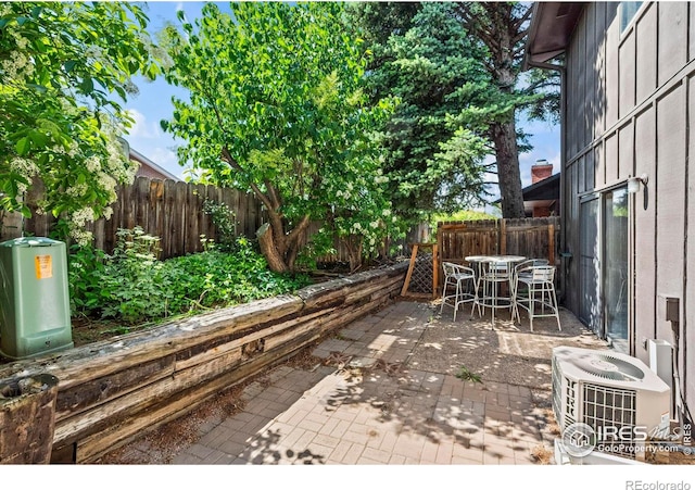 2840 W 21st St Unit 14, Greeley, CO 80634 - fenced backyard with central AC, outdoor dining space, and a patio area