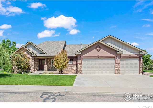 29 Pioneer Pl, Eaton, CO 80615 - view of front of house with board and batten siding, a garage, stone siding, a front lawn, and concrete driveway