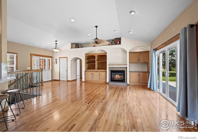29 Pioneer Pl, Eaton, CO 80615 - unfurnished living room featuring vaulted ceiling, light wood finished floors, a ceiling fan, and healthy amount of natural light