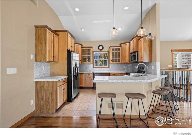 29 Pioneer Pl, Eaton, CO 80615 - kitchen with stainless steel refrigerator with ice dispenser, a peninsula, a sink, glass insert cabinets, and healthy amount of natural light