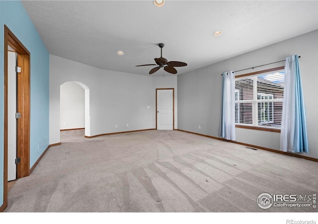 29 Pioneer Pl, Eaton, CO 80615 - empty room featuring arched walkways, carpet, a ceiling fan, baseboards, and recessed lighting