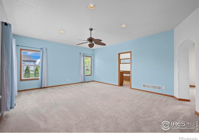 29 Pioneer Pl, Eaton, CO 80615 - carpeted empty room with arched walkways, baseboards, a ceiling fan, and recessed lighting