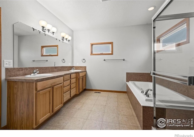 29 Pioneer Pl, Eaton, CO 80615 - bathroom with double vanity, a bath, baseboards, and tile patterned flooring