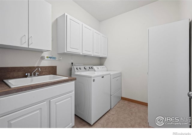 29 Pioneer Pl, Eaton, CO 80615 - laundry room with washer and clothes dryer, cabinet space, light tile patterned flooring, and baseboards
