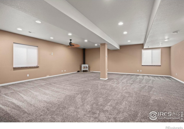 29 Pioneer Pl, Eaton, CO 80615 - basement featuring a wood stove, baseboards, carpet floors, recessed lighting, and a ceiling fan