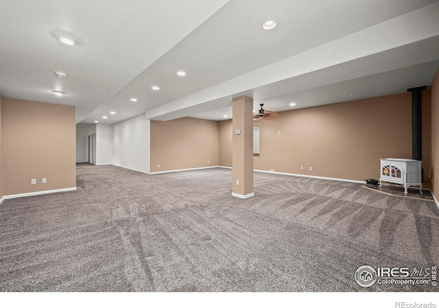 29 Pioneer Pl, Eaton, CO 80615 - finished below grade area featuring carpet flooring, baseboards, a wood stove, recessed lighting, and ceiling fan