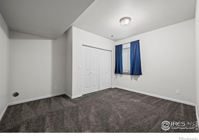 29 Pioneer Pl, Eaton, CO 80615 - unfurnished bedroom with dark colored carpet, baseboards, a closet, and a textured ceiling