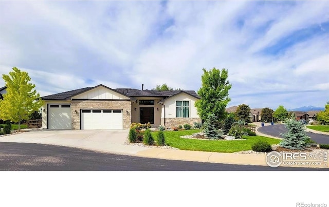 4236 Carroway Seed Ct, Johnstown, CO 80534 - view of front of home featuring stone siding, an attached garage, and driveway