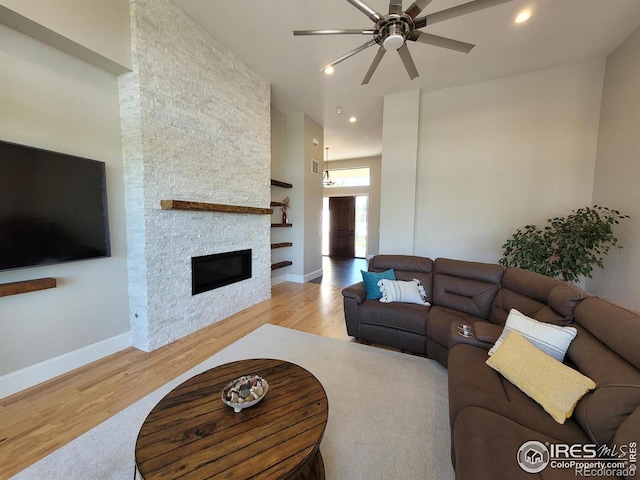4236 Carroway Seed Ct, Johnstown, CO 80534 - living area featuring a ceiling fan, wood finished floors, a fireplace, recessed lighting, and baseboards