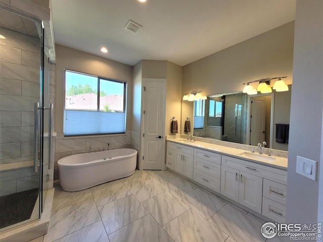4236 Carroway Seed Ct, Johnstown, CO 80534 - bathroom with marble finish flooring, a shower stall, double vanity, a soaking tub, and recessed lighting
