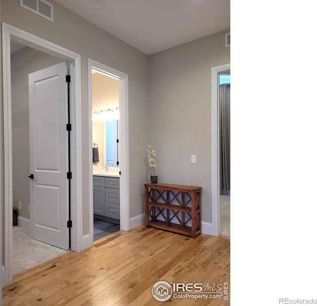 4236 Carroway Seed Ct, Johnstown, CO 80534 - hall with light wood-style flooring and baseboards