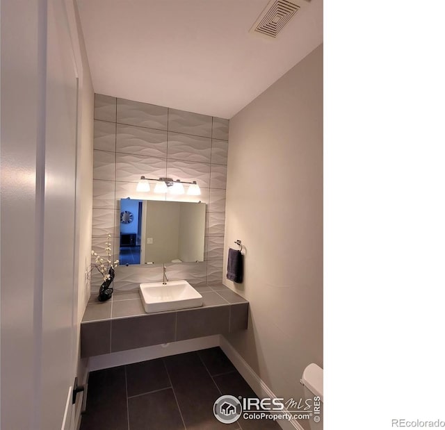 4236 Carroway Seed Ct, Johnstown, CO 80534 - half bathroom with a sink, tile patterned floors, baseboards, and toilet