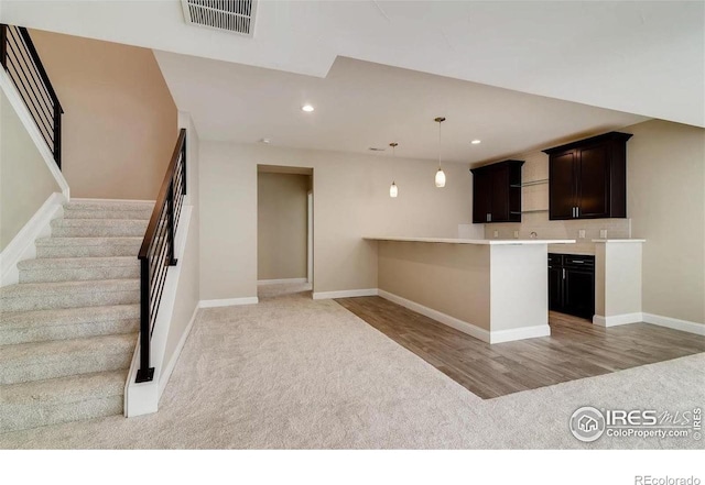 4236 Carroway Seed Ct, Johnstown, CO 80534 - kitchen with light carpet, recessed lighting, a peninsula, baseboards, and light countertops