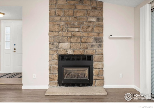 8423 Everett Way Unit A, Arvada, CO 80005 - detailed view of wood finished floors, a large fireplace, and baseboards