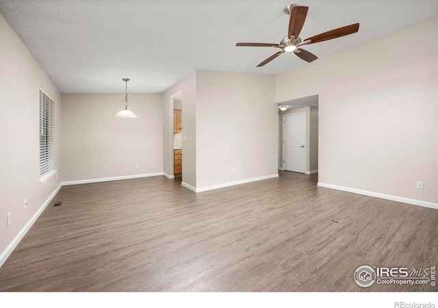 8423 Everett Way Unit A, Arvada, CO 80005 - spare room featuring wood finished floors, a ceiling fan, and baseboards