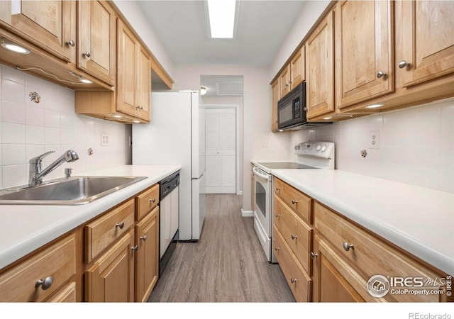8423 Everett Way Unit A, Arvada, CO 80005 - kitchen with white range with electric stovetop, black microwave, a sink, dishwasher, and backsplash