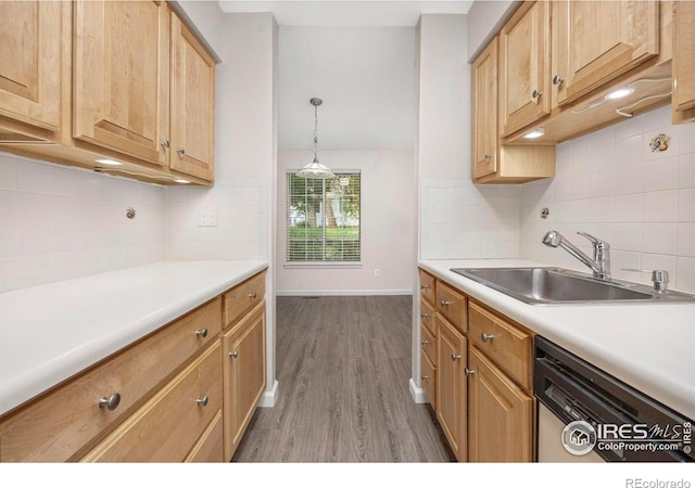8423 Everett Way Unit A, Arvada, CO 80005 - kitchen featuring dishwasher, a sink, wood finished floors, and tasteful backsplash