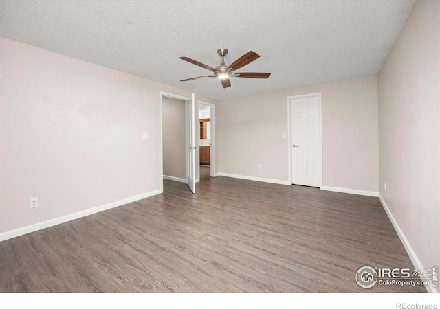 8423 Everett Way Unit A, Arvada, CO 80005 - unfurnished room featuring ceiling fan, wood finished floors, a textured ceiling, and baseboards