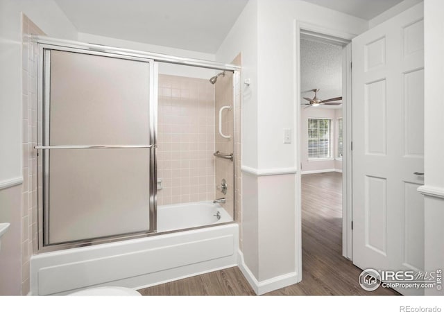 8423 Everett Way Unit A, Arvada, CO 80005 - full bathroom featuring wood finished floors, shower / bath combination with glass door, baseboards, ceiling fan, and toilet