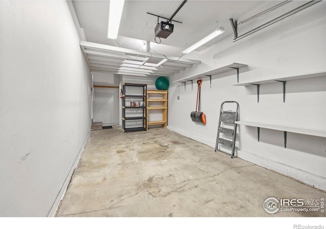 8423 Everett Way Unit A, Arvada, CO 80005 - garage featuring a garage door opener and baseboards