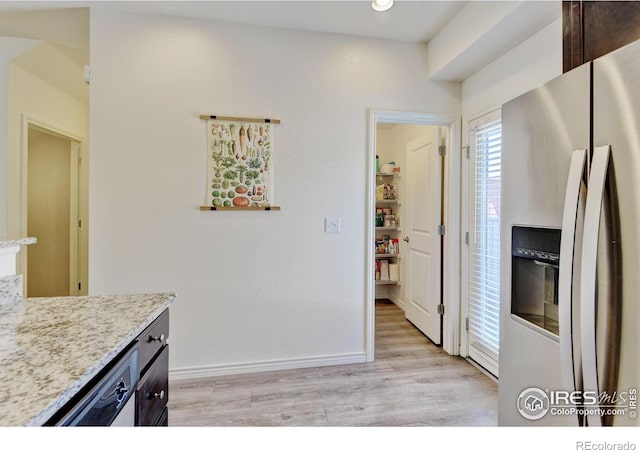 1240 Wren Ct Unit D, Longmont, CO 80501 - kitchen featuring stainless steel refrigerator with ice dispenser, light wood-style flooring, baseboards, light stone counters, and recessed lighting