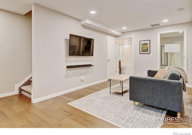 1240 Wren Ct Unit D, Longmont, CO 80501 - living room featuring wood finished floors, baseboards, stairway, and recessed lighting