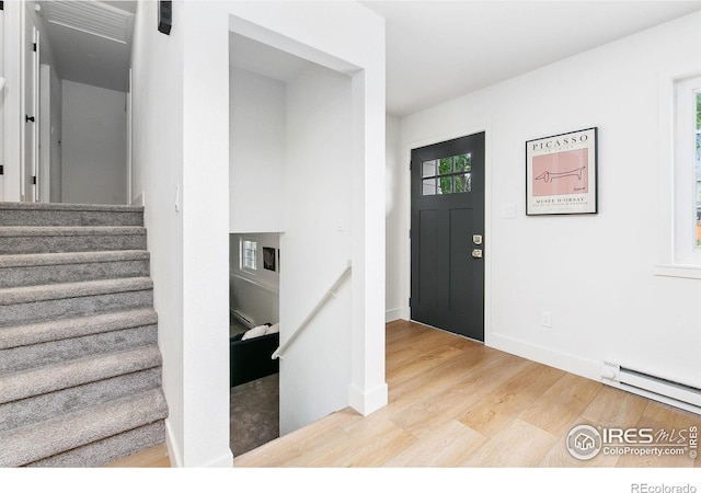 4329 Main St, Timnath, CO 80547 - entrance foyer with wood finished floors, baseboard heating, baseboards, and stairway