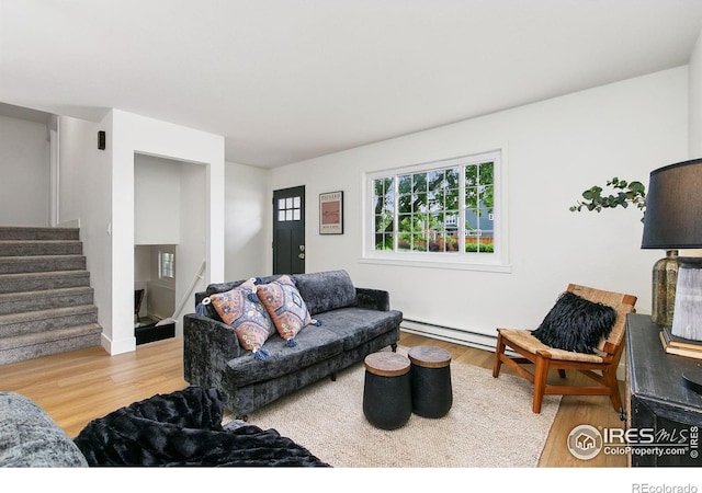 4329 Main St, Timnath, CO 80547 - living room with wood finished floors, stairs, a baseboard heating unit, and baseboards