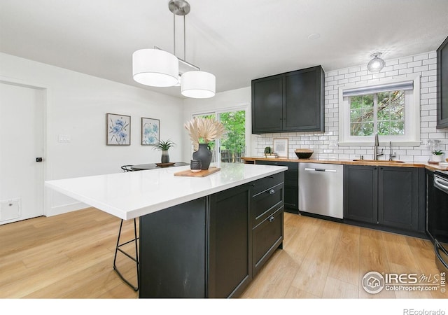4329 Main St, Timnath, CO 80547 - kitchen featuring dishwasher, a sink, light wood-style flooring, and decorative backsplash
