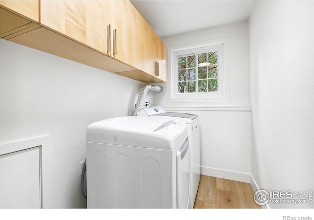 4329 Main St, Timnath, CO 80547 - washroom featuring cabinet space, light wood-type flooring, washing machine and clothes dryer, and baseboards