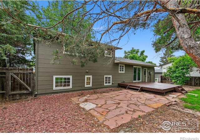 4329 Main St, Timnath, CO 80547 - rear view of house featuring a deck, a patio area, and a gate
