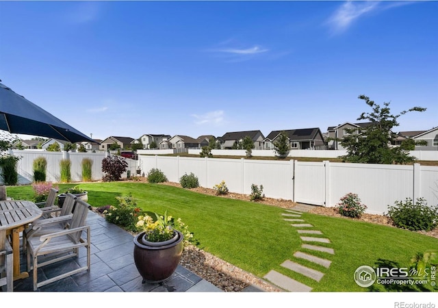 4521 Devereux Dr, Windsor, CO 80550 - fenced backyard with a residential view, a patio area, and outdoor dining space
