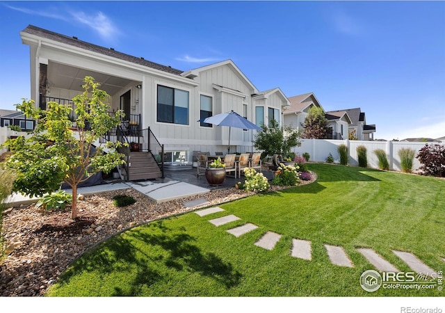 4521 Devereux Dr, Windsor, CO 80550 - rear view of house featuring board and batten siding, a patio, and an outdoor living space